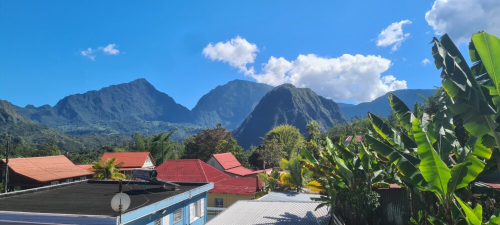 Colorful roofs of Hell-Bourg in front of the ramparts of the Salazie cirque, Réunion